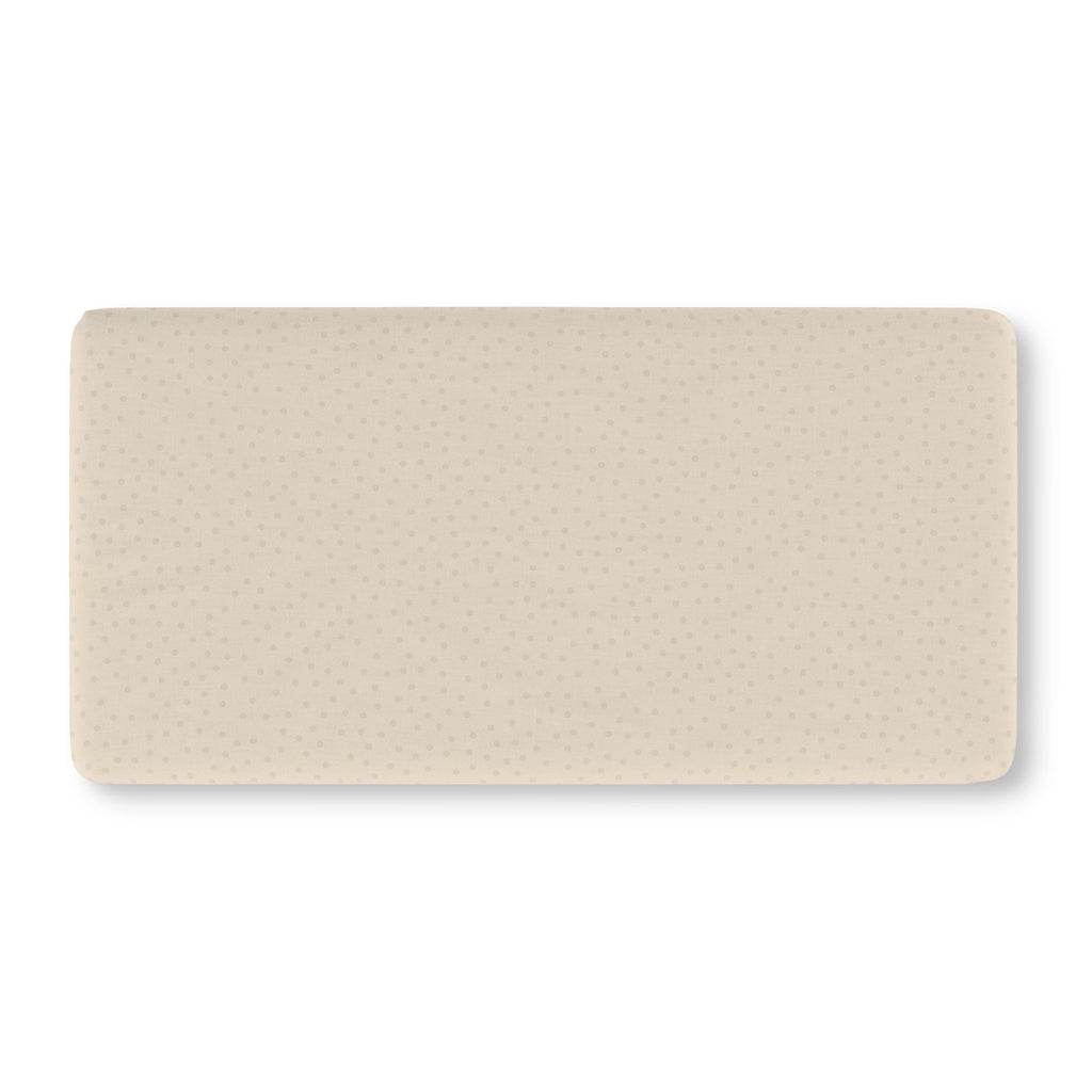 Beige Polka Dot Crib Sheet laid flat in Standard size with small tonal dots on warm beige
