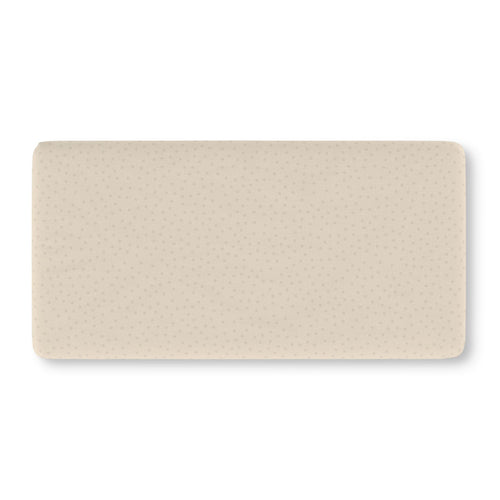 Beige Polka Dot Crib Sheet laid flat in Standard size with small tonal dots on warm beige