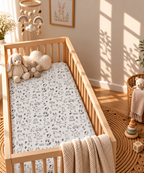 Black and White Woodland Crib Sheet in a wooden crib in a sunlit nursery