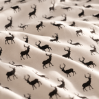 Close-up of the Black Reindeer Crib Sheet fabric showing black reindeer silhouettes on white