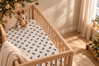 Black Reindeer Crib Sheet in a wooden crib in a sunlit nursery