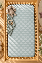 Blue Boho Rainbow Crib Sheet seen from above in a wooden crib