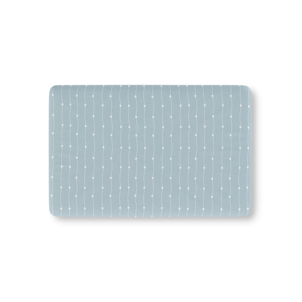 Blue Heart Stripe Crib Sheet laid flat in Mini size with wavy white lines and tiny hearts on dusty blue