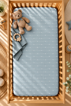 Blue Heart Stripe Crib Sheet seen from above in a wooden crib