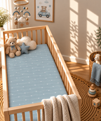 Blue Heart Stripe Crib Sheet in a wooden crib in a sunlit nursery