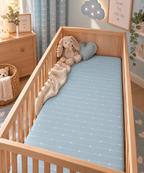 Blue Heart Stripe Crib Sheet on a wooden crib mattress in a baby boy nursery