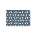 Blue Sheep Crib Sheet laid flat in Mini size with white woolly sheep and tan clouds on dusty blue