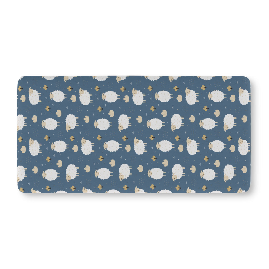 Blue Sheep Crib Sheet laid flat in Standard size with white woolly sheep and tan clouds on dusty blue