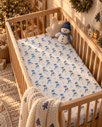 Blue Snowman Crib Sheet on a wooden crib mattress in a Christmas nursery