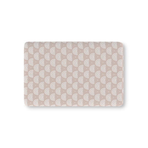 Blush Boho Rainbow Crib Sheet laid flat in Mini size with white rainbow arches on blush