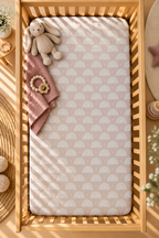 Blush Boho Rainbow Crib Sheet seen from above in a wooden crib