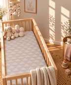 Blush Boho Rainbow Crib Sheet in a wooden crib in a sunlit nursery