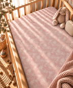 Blush Pink Lace Floral Crib Sheet fitted in a wooden crib with a plush toy