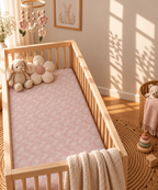 Blush Pink Lace Floral Crib Sheet in a wooden crib in a sunlit nursery