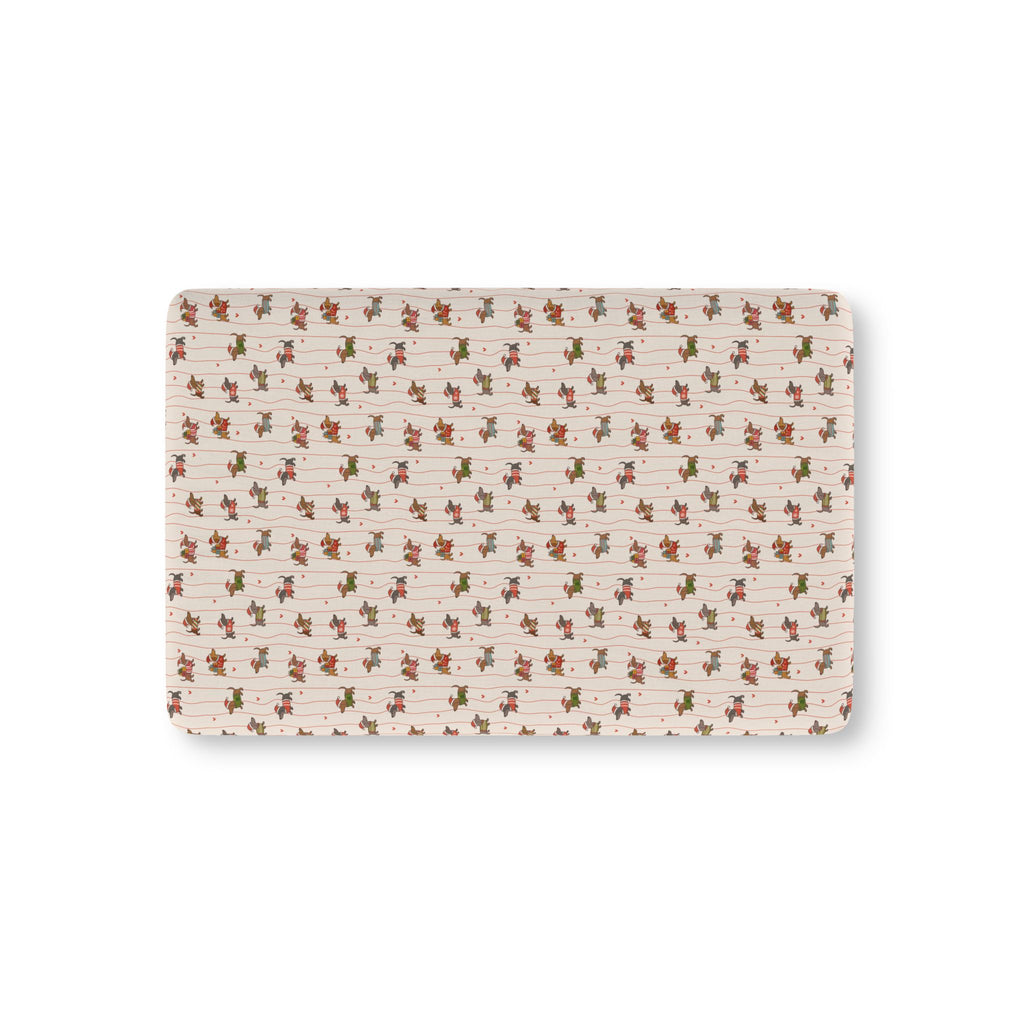 Christmas Dachshund Crib Sheet laid flat in Mini size with dachshunds in holiday sweaters on cream