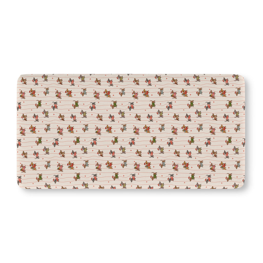 Christmas Dachshund Crib Sheet laid flat in Standard size with dachshunds in holiday sweaters on cream