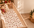Christmas Dachshund Crib Sheet in a wooden crib in a sunlit nursery