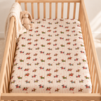Christmas Dachshund Crib Sheet seen from above in a wooden crib