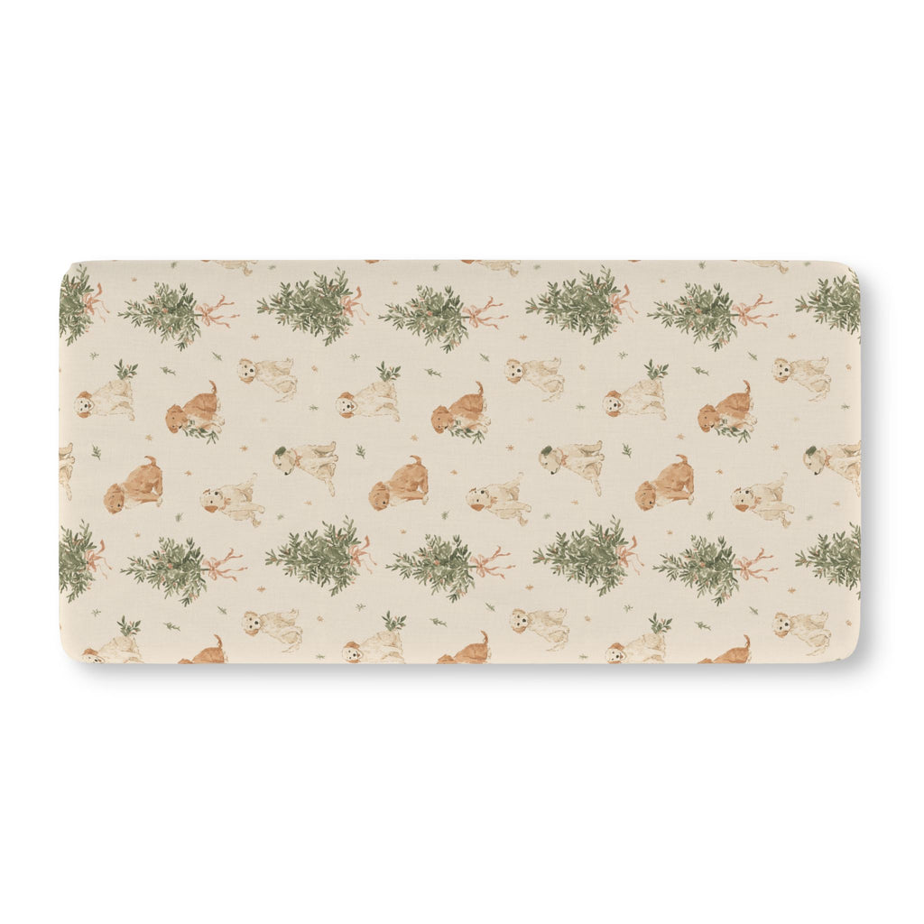 Christmas Puppy Crib Sheet laid flat in Standard size with puppies and little pine trees on cream