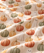 Close-up of the Cream Pumpkin Ghost Crib Sheet fabric showing watercolor pumpkins and little ghosts on cream