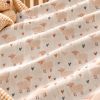 Close-up of the Cream Sheep Heart Crib Sheet fabric showing cream sheep and little hearts on cream