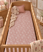Dusty Rose Lace Floral Crib Sheet on a wooden crib mattress in a baby girl nursery