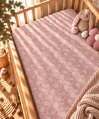 Dusty Rose Lace Floral Crib Sheet fitted in a wooden crib with a plush toy