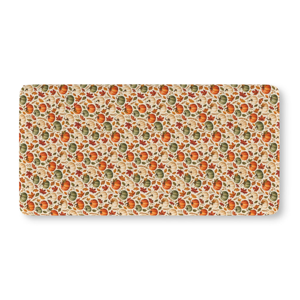Fall Pumpkin Crib Sheet laid flat in Standard size with pumpkins and autumn leaves on cream