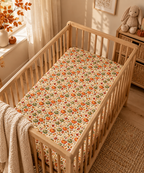 Fall Pumpkin Crib Sheet on a wooden crib mattress in a fall nursery