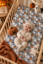 Smiling baby lying on the Gray Halloween Ghost Crib Sheet