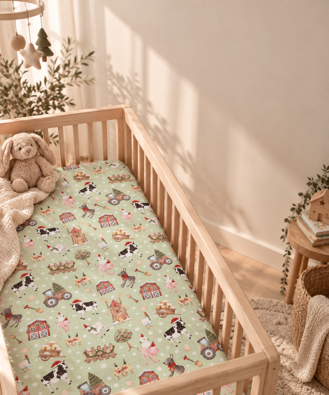 Green Christmas Farm Crib Sheet in a wooden crib in a sunlit nursery
