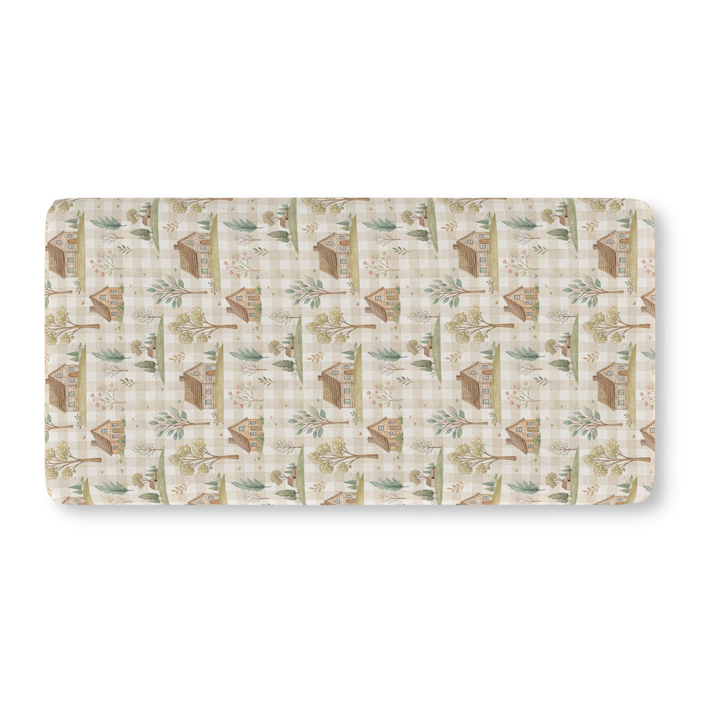 Green Gingham Cottage Crib Sheet laid flat in Standard size with cottages and trees on sage green gingham
