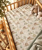 Green Gingham Cottage Crib Sheet fitted in a wooden crib with a plush toy