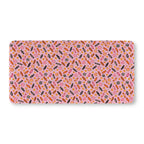 Halloween Candy Crib Sheet laid flat in Standard size with wrapped candy, lollipops and candy corn on pink