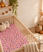 Halloween Candy Crib Sheet in a wooden crib in a sunlit nursery