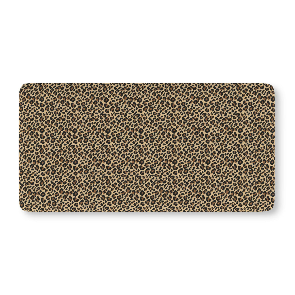 Leopard Print Crib Sheet laid flat in Standard size with black and brown leopard spots on tan