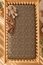 Leopard Print Crib Sheet seen from above in a wooden crib