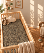Leopard Print Crib Sheet in a wooden crib in a sunlit nursery