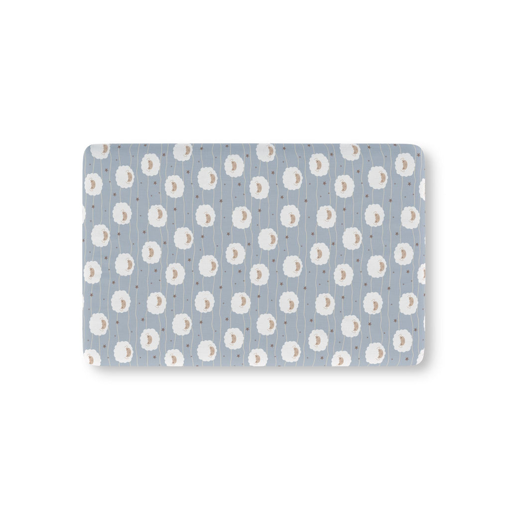 Light Blue Sheep Crib Sheet laid flat in Mini size with round fluffy sheep, wavy lines and tiny stars on light blue