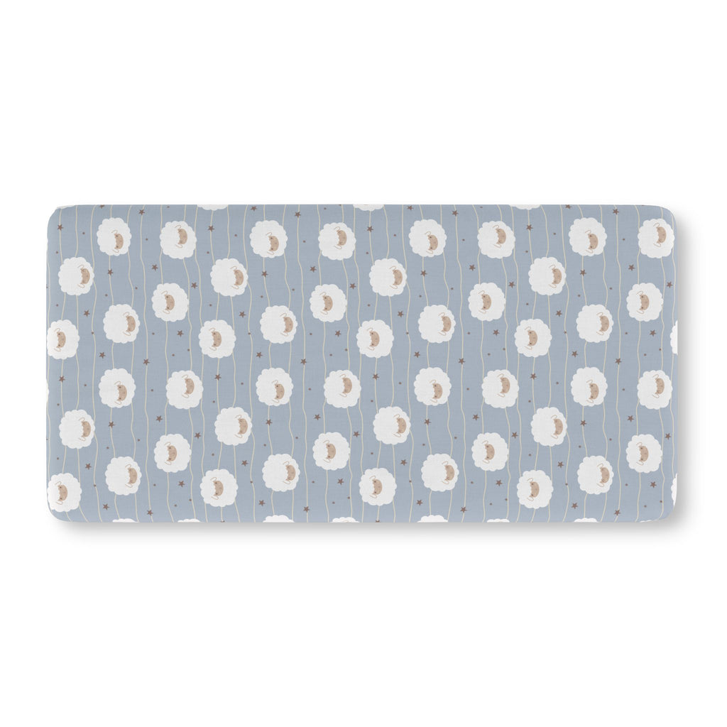 Light Blue Sheep Crib Sheet laid flat in Standard size with round fluffy sheep, wavy lines and tiny stars on light blue