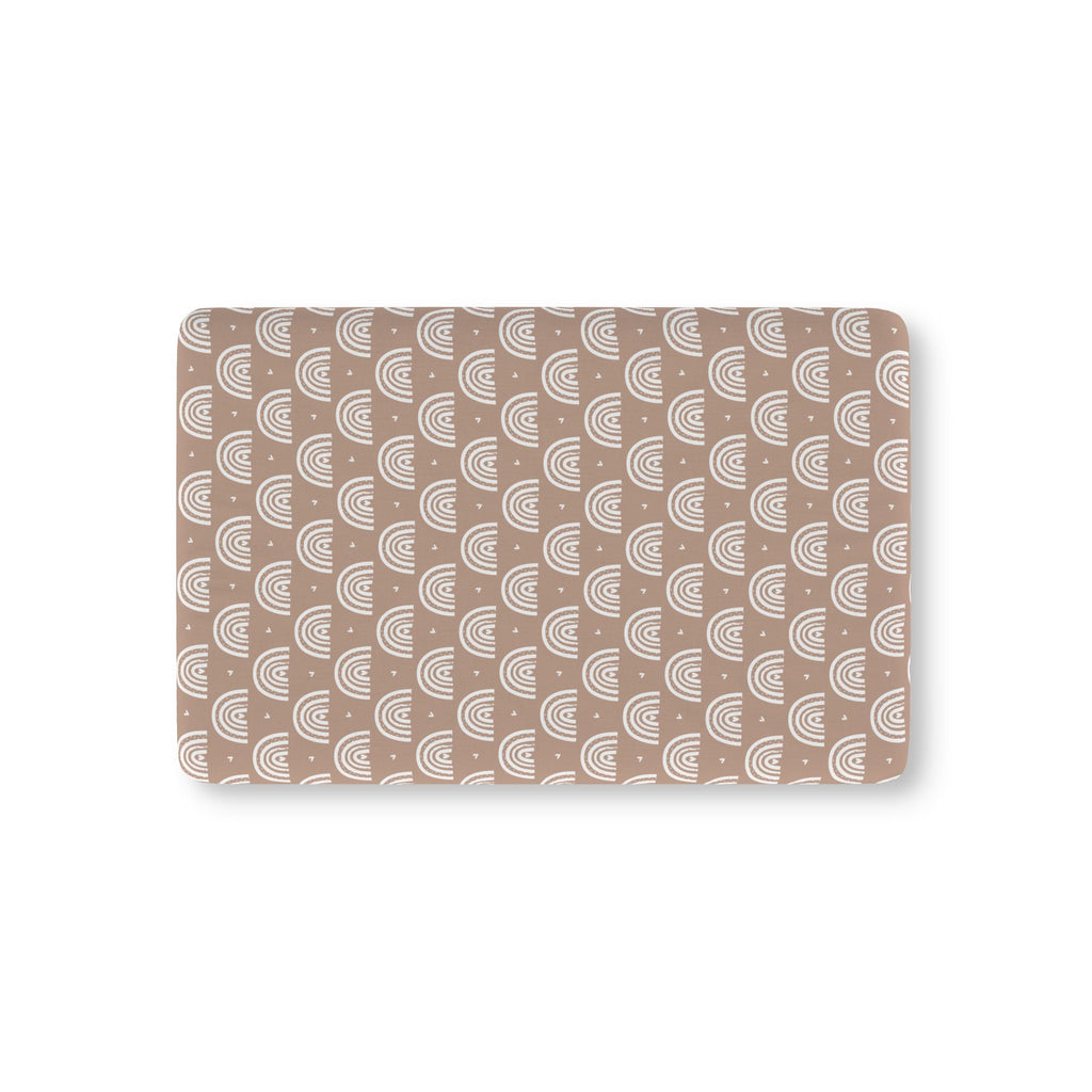 Mauve Boho Rainbow Crib Sheet laid flat in Mini size with white rainbow arches on mauve
