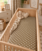 Olive Heart Crib Sheet on a wooden crib mattress in a neutral nursery