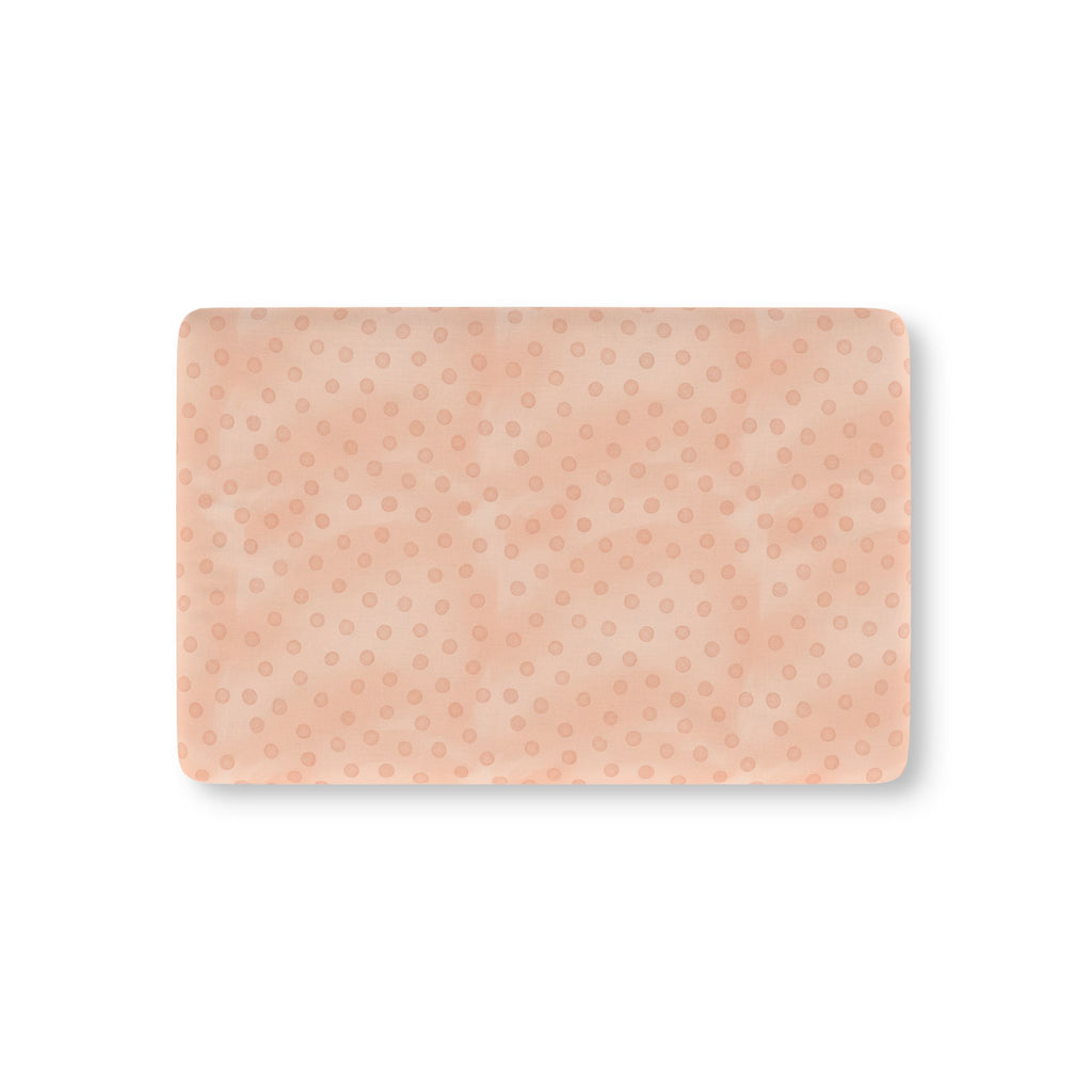 Peach Polka Dot Crib Sheet laid flat in Mini size with watercolor dots on peach pink