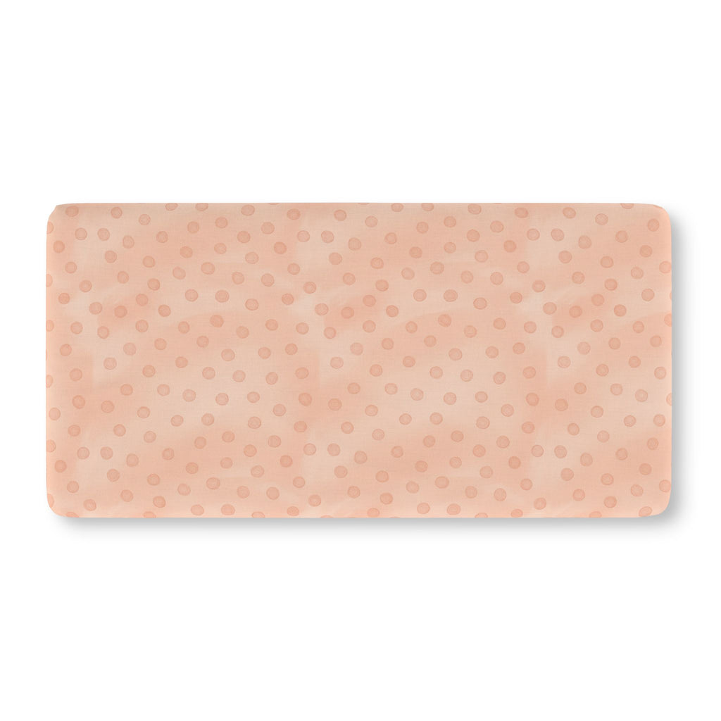 Peach Polka Dot Crib Sheet laid flat in Standard size with watercolor dots on peach pink