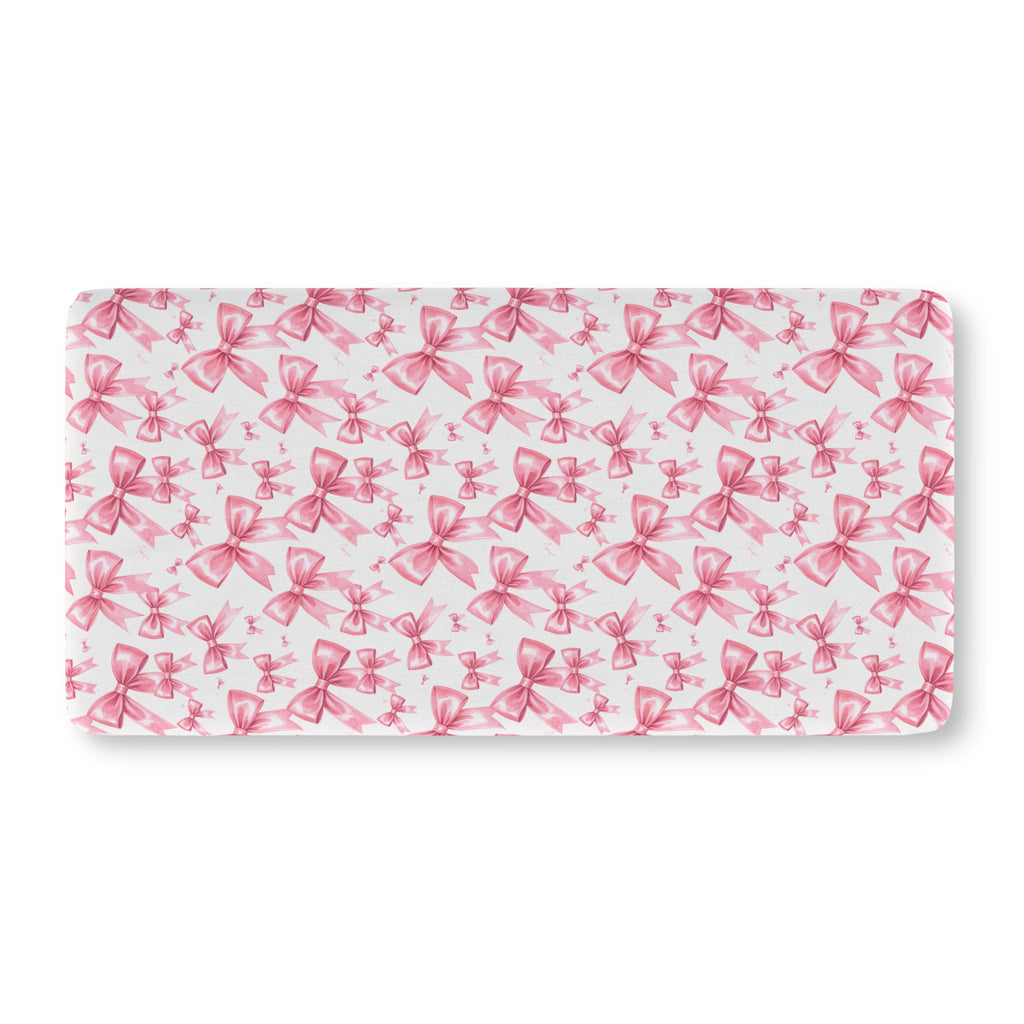 Pink Bow Crib Sheet laid flat in Standard size with pink ribbon bows on white