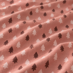 Close-up of the Pink Christmas Tree Crib Sheet fabric showing blush and berry Christmas trees on dusty rose