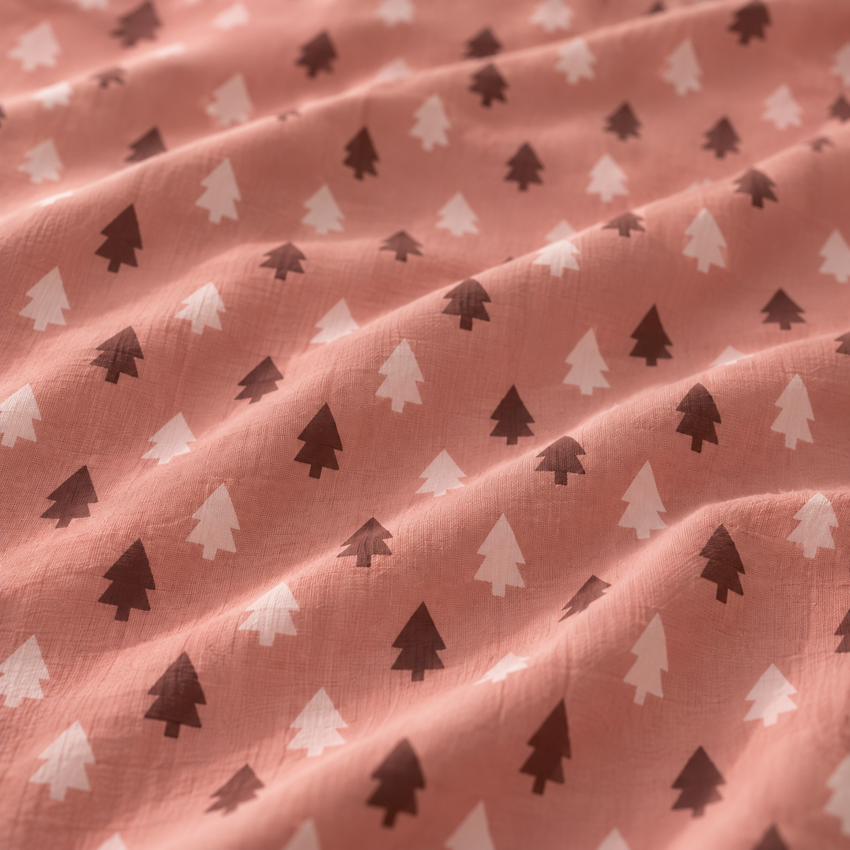 Close-up of the Pink Christmas Tree Crib Sheet fabric showing blush and berry Christmas trees on dusty rose
