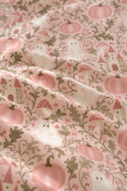Close-up of the Pink Ghost Garden Crib Sheet fabric showing ghosts, pink pumpkins and green vines on pink
