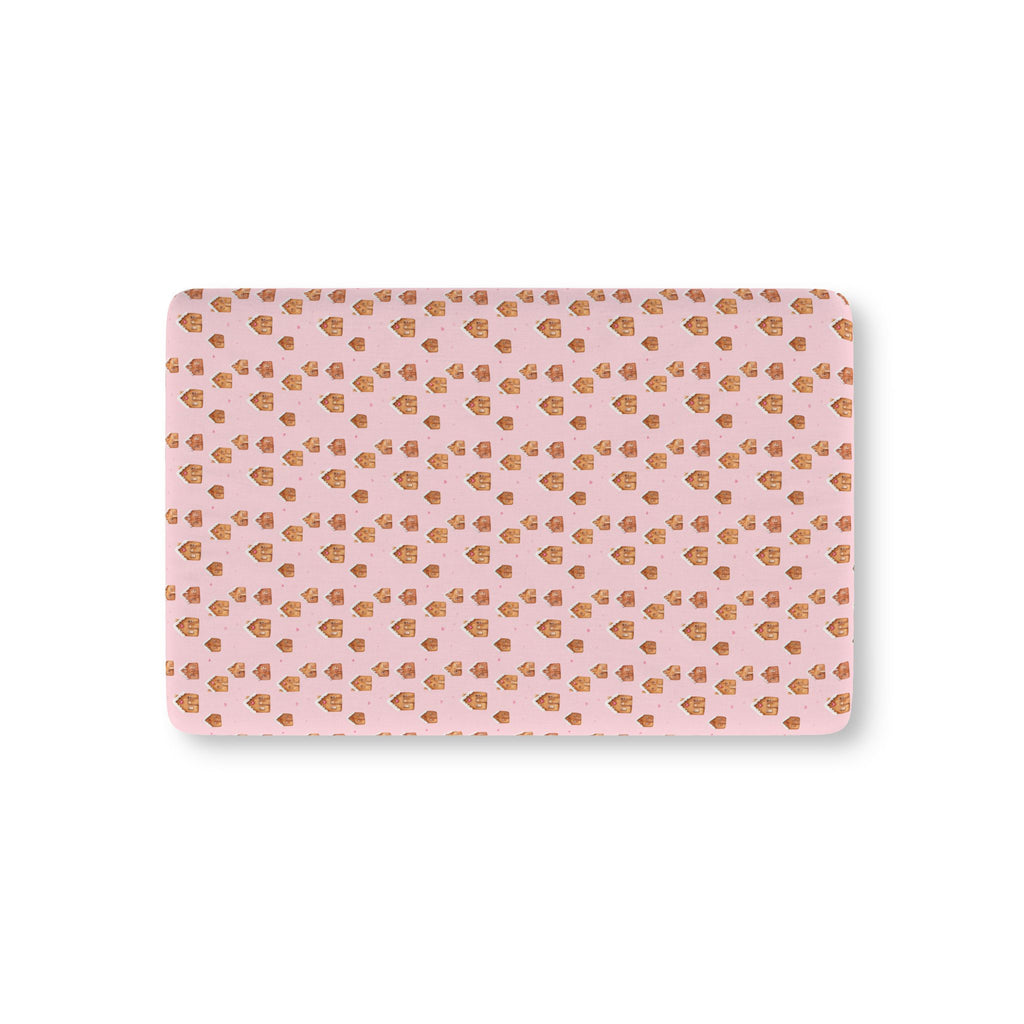 Pink Gingerbread House Crib Sheet laid flat in Mini size with gingerbread houses on pink