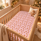 Pink Gingerbread House Crib Sheet on a wooden crib mattress in a Christmas nursery